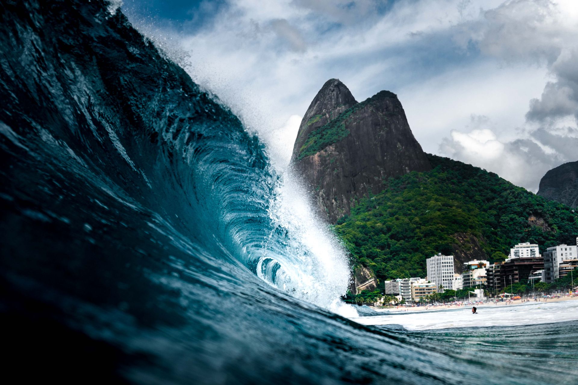 Wave breaking off Rio de Janeiro with Two Brothers mountain and Ipanema beach in the background